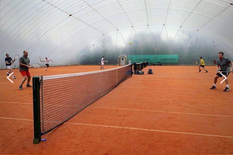 Members playing on indoor clay courts inside the Billericay Lawn Tennis Club air dome