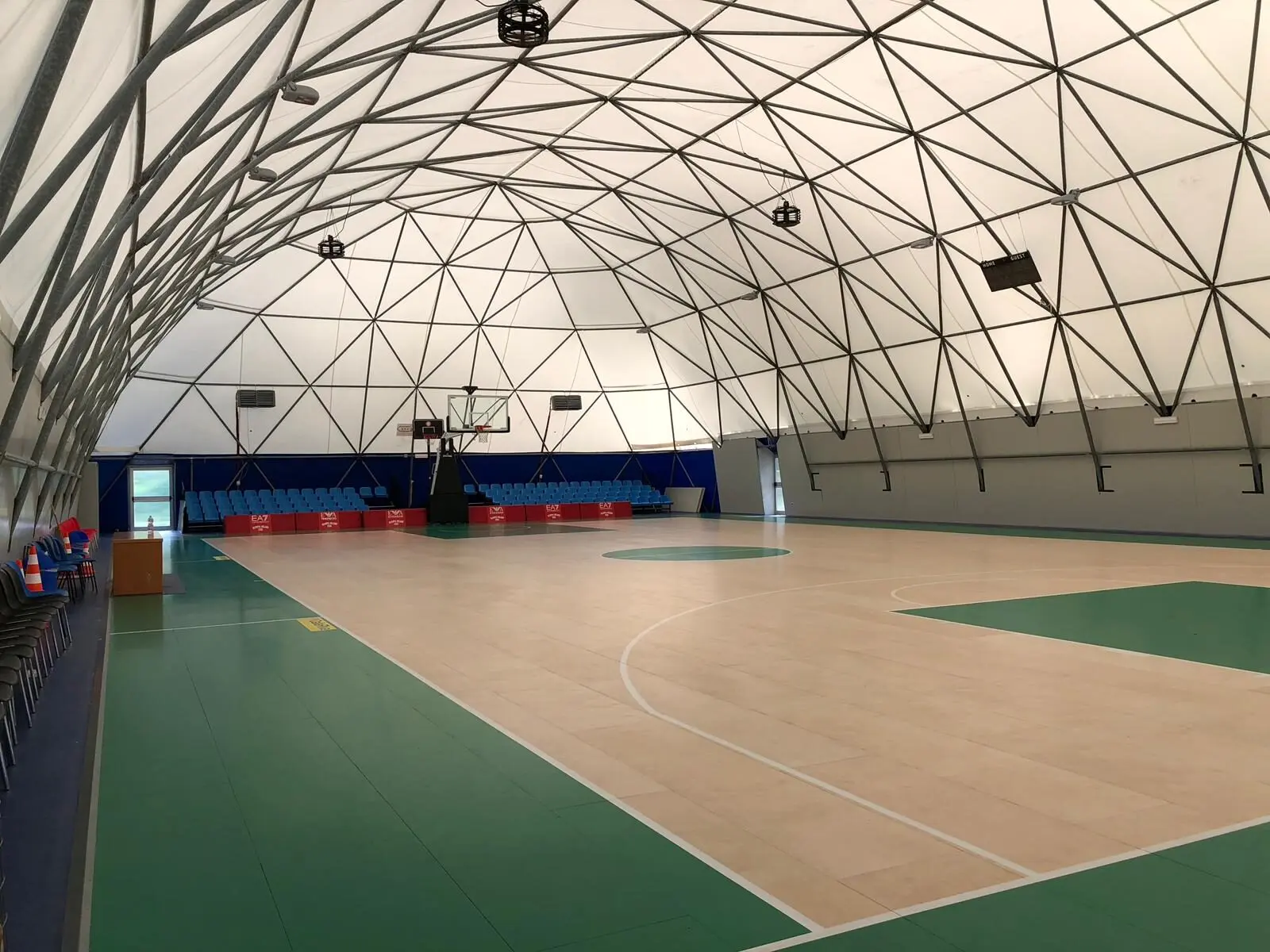 Inside a Covair geodesic hall - a full-size court under one clear span